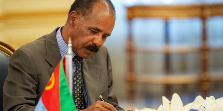 In this photograph released by the state-run Saudi Press Agency, Eritrean President Isaias Afwerki signs a peace accord with Ethiopia in Jiddah, Saudi Arabia on Sunday, Sept. 16, 2018. The leaders of Ethiopia and Eritrea were in Saudi Arabia on Sunday to sign a peace accord between the two East African nations. (Saudi Press Agency via AP)