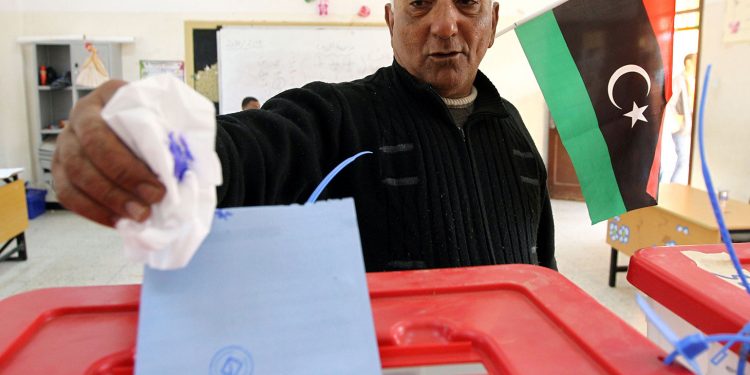 A Libyan man casts his vote to elect a constituent assembly at a polling station in the eastern city of Benghazi on Feb, 20, 2014.