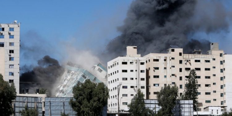 The al-Jalaa tower housing Al Jazeera and The Associated Press offices collapses after being hit by an Israeli missile in Gaza City.