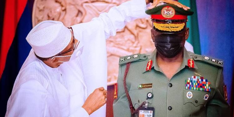 President Muhammadu Buhari decorating Attahiru as Chief of Army Staff in January 2021.