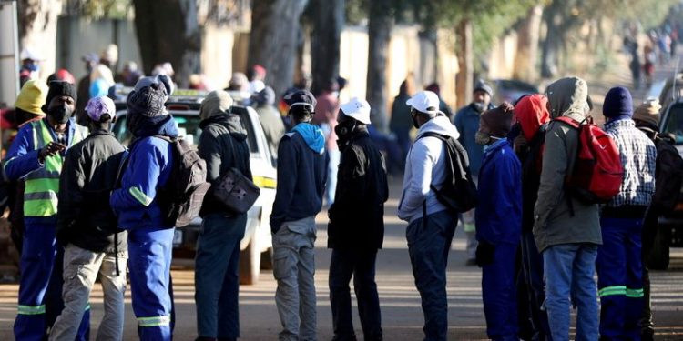 FILE PHOTO: Job seekers stand outside a construction site ahead of the release of the unemployement numbers by Statistics South Africa, in Eikenhof, south of Johannesburg, South Africa, June 23, 2020. REUTERS/Siphiwe Sibeko/File Photo/File Photo