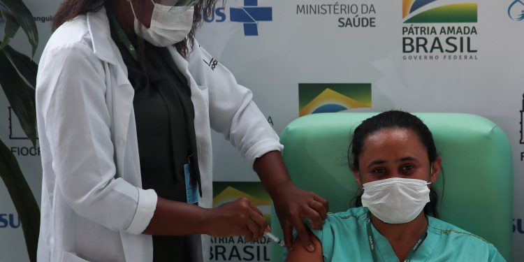 FILE PHOTO: A healthcare worker receives the AstraZeneca/Oxford coronavirus disease (COVID-19) vaccine at FioCruz Institute in Rio de Janeiro, Brazil January 23, 2021. REUTERS/Ricardo Moraes/File Photo/File Photo