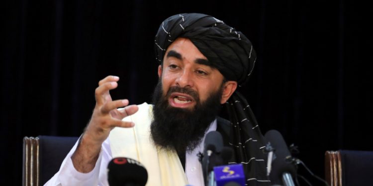 Taliban spokesman Zabihullah Mujahid speaks at his first news conference, in Kabul, Afghanistan, Tuesday, Aug. 17, 2021. For years, Mujahid had been a shadowy figure issuing statements on behalf of the militants. Mujahid vowed Tuesday that the Taliban would respect women's rights, forgive those who resisted them and ensure a secure Afghanistan as part of a publicity blitz aimed at convincing world powers and a fearful population that they have changed. (AP Photo/Rahmat Gul)