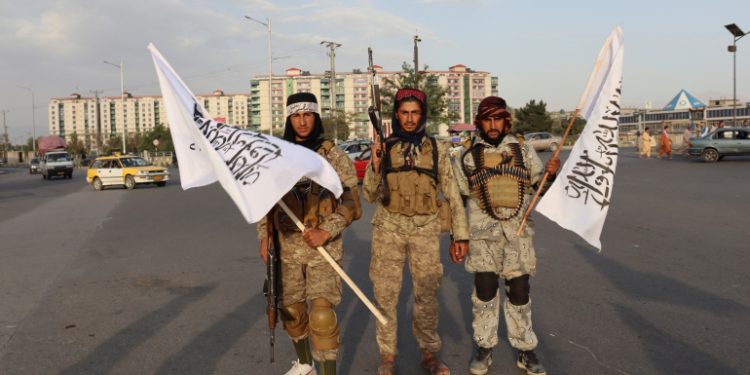 Taliban fighters hold Taliban flags in Kabul, Afghanistan, Monday, Aug. 30, 2021. Many Afghans are anxious about the Taliban rule and are figuring out ways to get out of Afghanistan. But it's the financial desperation that seems to hang heavy over the city. (AP Photo/Khwaja Tawfiq Sediqi)