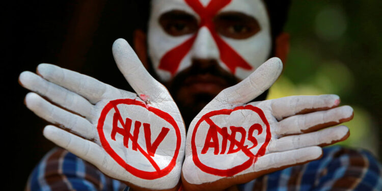 A student displays his hands painted with messages as he poses during an HIV/AIDS awareness campaign.