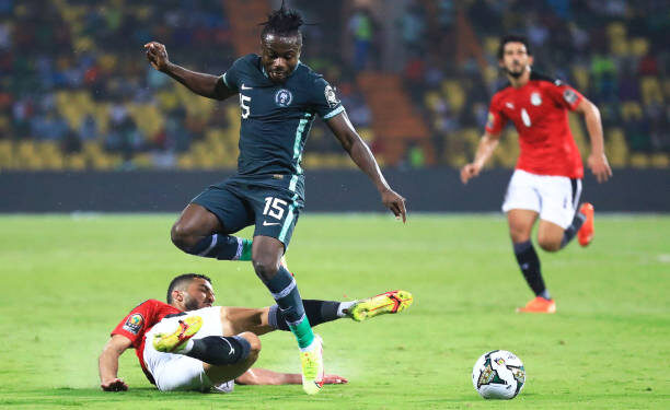 Nigeria's forward Moses Simon (C) is tackled by Egypt's defender Mohamed Abdel-Moneim (L)  during the Group D Africa Cup of Nations (CAN) 2021 football match between Nigeria and Egypt at Stade Roumde Adjia in Garoua on January 11, 2022. (Photo by Daniel BELOUMOU OLOMO / AFP) (Photo by DANIEL BELOUMOU OLOMO/AFP via Getty Images)