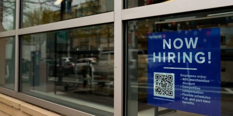 An employee hiring sign with a QR code is seen in a window of a business in Arlington, Virginia, US, April 7, 2023. REUTERS/Elizabeth Frantz