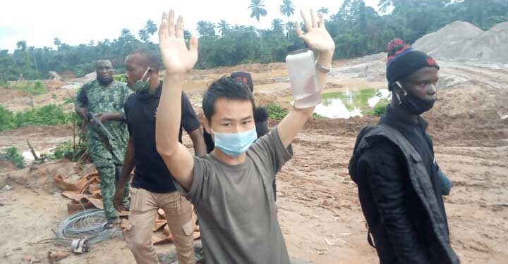 A Chinese national suspected of engaging in illegal mining in southwestern Nigeria who was detained by the Amotekun joint task force. Photo via Premium Times.