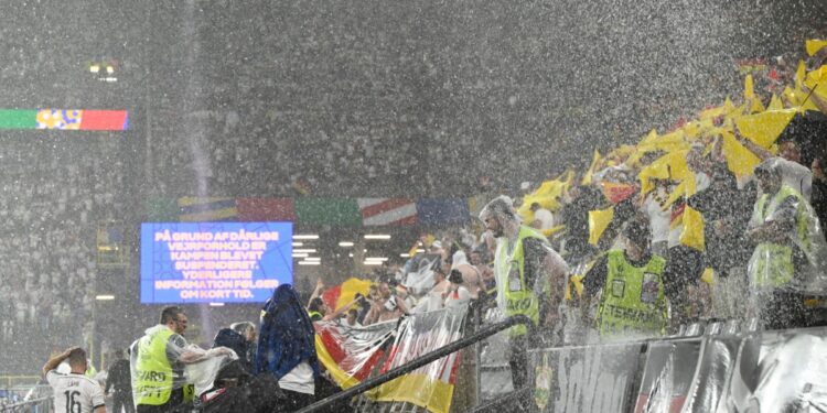 Heavy rain pours over the BVB Stadion during the UEFA Euro 2024 round of 16 football match between Germany and Denmark, in Dortmund on June 29, 2024. (Photo by INA FASSBENDER / AFP)