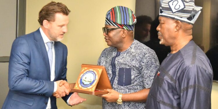 The NDDC Executive Director, Projects, Sir Victor Antai (middle), presenting a plaque to the UNITAR team leader, Mr. Olivier Van Damme, during a courtesy visit at the Commission’s headquarters in Port Harcourt. On the right is the NDDC Executive Director, Corporate Services, Hon. Ifedayo Abegunde.