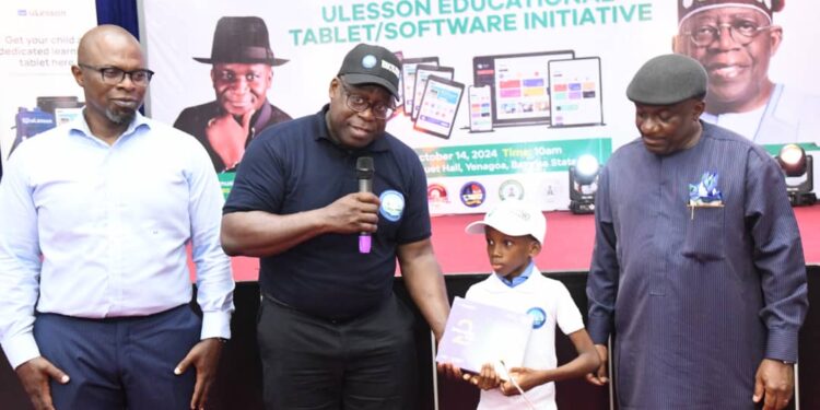 NDDC Director, Educational Health and Social Services, Dr George Uzonwanne,  presenting U-Lesson Educational Tablet