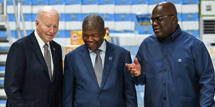 L-R: President Joe Biden, Angola President Joao Lourenco and Democratic Republic of Congo President Félix Tshisekedi speak while looking at a model during their visit to the Carrinho Food Processing Factory near Benguela on December 4, 2024. AFP