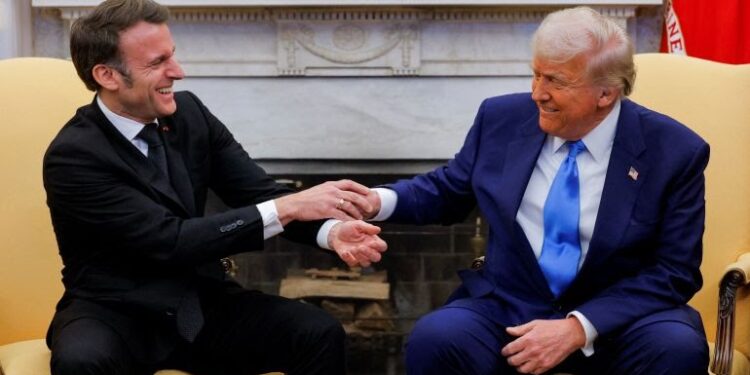 French President Emmanuel Macron and US President Donald Trump react during their meeting at the White House, February 24, 2025